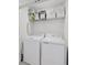 Convenient laundry room with a full-size washer, dryer, and overhead storage shelf at 15051 Ginetti St, Nokomis, FL 34275