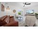 Bright living room features a sliding glass door, a modern ceiling fan, and stylish furniture at 15051 Ginetti St, Nokomis, FL 34275