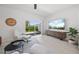 Stylish living room features a sliding glass door to the backyard and a modern entertainment center at 15051 Ginetti St, Nokomis, FL 34275