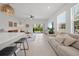 Open-concept living room boasts ample natural light, neutral decor, and seamless access to the outdoor patio at 15051 Ginetti St, Nokomis, FL 34275