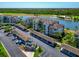 A birds-eye view reveals a condo building by a lake and golf course, enhanced by covered parking at 16804 Vardon Ter # 205, Bradenton, FL 34211