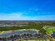 Stunning aerial view of a lakeside community featuring a golf course and lush green surroundings at 16804 Vardon Ter # 205, Bradenton, FL 34211