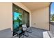 Condo balcony area with patio furniture overlooking a serene lake at 16804 Vardon Ter # 205, Bradenton, FL 34211