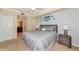 Well-lit bedroom with ceiling fan, two side tables, and ensuite bathroom at 16804 Vardon Ter # 205, Bradenton, FL 34211