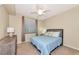 Bedroom features neutral walls, ceiling fan, window and carpeting at 16804 Vardon Ter # 205, Bradenton, FL 34211