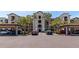 Beautiful condo building with palm trees, covered parking, and manicured landscaping at 16804 Vardon Ter # 205, Bradenton, FL 34211