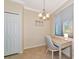 Bright breakfast nook with light wood desk, decorative chandelier, and a window for lots of natural light at 16804 Vardon Ter # 205, Bradenton, FL 34211