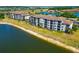 Gorgeous condo building overlooking lake, featuring screened patios and lush landscaping at 16804 Vardon Ter # 205, Bradenton, FL 34211