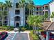 Elegant condo building featuring private balconies, lush landscaping, and convenient parking spaces at 16804 Vardon Ter # 205, Bradenton, FL 34211