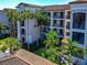 Beautiful condo complex with multiple stories, balconies, tile roof, and lush tropical landscaping at 16804 Vardon Ter # 205, Bradenton, FL 34211