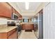 Well-lit kitchen with stainless steel appliances, granite countertops, and wooden cabinetry at 16804 Vardon Ter # 205, Bradenton, FL 34211