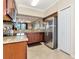 Open kitchen with granite counters, stainless steel appliances, and an opening to the living room at 16804 Vardon Ter # 205, Bradenton, FL 34211