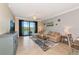 Comfortable living room featuring tile floors, a ceiling fan and a scenic balcony view at 16804 Vardon Ter # 205, Bradenton, FL 34211