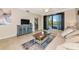 Comfortable living room featuring a large sectional, tile floors and a scenic balcony at 16804 Vardon Ter # 205, Bradenton, FL 34211