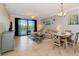 Open-concept living and dining area with tile floors and a sliding door to the balcony at 16804 Vardon Ter # 205, Bradenton, FL 34211