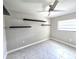 Bedroom with a ceiling fan, floating shelves, and tiled floor at 2204 34Th W St, Bradenton, FL 34205