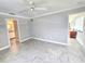 Relaxing bedroom with tiled floors, ceiling fan, and adjoining bathroom and closet at 2204 34Th W St, Bradenton, FL 34205