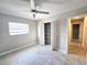 Bright bedroom featuring tile floors, a ceiling fan, window, and closet for ample storage at 2204 34Th W St, Bradenton, FL 34205