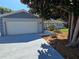 Attached two-car garage with a concrete driveway and beautifully landscaped front yard at 2204 34Th W St, Bradenton, FL 34205