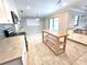 Open kitchen with a butcher block island, stainless steel appliances, and tile flooring at 2204 34Th W St, Bradenton, FL 34205