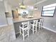Kitchen island with marble countertop and bar stool seating at 2204 34Th W St, Bradenton, FL 34205