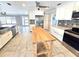 Spacious kitchen with stainless steel appliances, white cabinetry, and center butcher block island at 2204 34Th W St, Bradenton, FL 34205