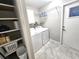 Functional laundry room with washer, dryer, shelving, and ample storage space at 2204 34Th W St, Bradenton, FL 34205
