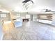 Open-concept living space with a kitchen island, tile flooring, and modern lighting fixtures at 2204 34Th W St, Bradenton, FL 34205