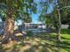 Backyard screened-in pool surrounded by lush green trees and grass at 2204 34Th W St, Bradenton, FL 34205