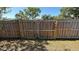 Wooden fence and gate enclosing the backyard for privacy and security at 2231 Lockwood Meadows Way, Sarasota, FL 34234
