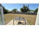 Spacious backyard featuring a patio with table and a well-maintained lawn, perfect for outdoor activities at 2231 Lockwood Meadows Way, Sarasota, FL 34234