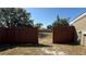 A partially fenced backyard featuring green grass and trees at 2231 Lockwood Meadows Way, Sarasota, FL 34234