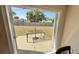 Backyard patio view showcasing outdoor table and chairs and grass yard with wood fence at 2231 Lockwood Meadows Way, Sarasota, FL 34234