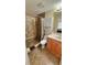 Bathroom with tiled shower, granite counters, updated fixtures, and built in shelves for storage at 2231 Lockwood Meadows Way, Sarasota, FL 34234