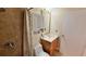 Updated bathroom features modern fixtures, a vanity with granite counter, and tiled shower with curtain at 2231 Lockwood Meadows Way, Sarasota, FL 34234