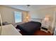 Bedroom featuring a queen bed, two nightstands, and a window; a tranquil retreat at 2231 Lockwood Meadows Way, Sarasota, FL 34234