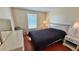 Bedroom featuring a queen bed, two nightstands, and a window; a tranquil retreat at 2231 Lockwood Meadows Way, Sarasota, FL 34234