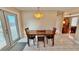 The dining area features tile flooring and a modern light fixture over a wood dining table at 2231 Lockwood Meadows Way, Sarasota, FL 34234