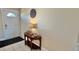 Warm entryway featuring a wood table with lamp and a decorative wall clock at 2231 Lockwood Meadows Way, Sarasota, FL 34234
