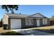 Charming exterior of home with attached garage and well-maintained yard at 2231 Lockwood Meadows Way, Sarasota, FL 34234