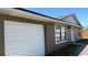 Angle exterior of home featuring garage, white trim, and dark paint at 2231 Lockwood Meadows Way, Sarasota, FL 34234