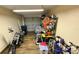 Functional garage featuring ample storage and durable tile flooring, perfect for organization and various hobbies at 2231 Lockwood Meadows Way, Sarasota, FL 34234
