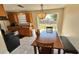 Cozy eat-in kitchen with wood cabinets, white tile floors, and an eat-in area with sliding doors to the backyard at 2231 Lockwood Meadows Way, Sarasota, FL 34234