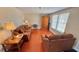 Comfortable living room featuring wood flooring, large windows, and modern decor at 2231 Lockwood Meadows Way, Sarasota, FL 34234