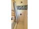 Shower featuring white and blue tiles, a shower curtain and modern fixtures at 2231 Lockwood Meadows Way, Sarasota, FL 34234