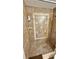 Walk-in shower featuring updated tile design and built-in shampoo and soap shelves at 2231 Lockwood Meadows Way, Sarasota, FL 34234