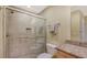 Tiled bathroom shower with a glass enclosure and convenient grab bars, next to the commode at 2259 Pueblo Ln # V38, Sarasota, FL 34231