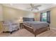 Inviting bedroom with a ceiling fan, a cozy chair, and a queen-size bed at 2259 Pueblo Ln # V38, Sarasota, FL 34231