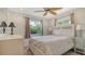 Relaxing bedroom with a ceiling fan, white furniture, and natural light from the window at 2259 Pueblo Ln # V38, Sarasota, FL 34231