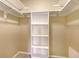Walk-in closet with built-in shelving for organized storage at 2259 Pueblo Ln # V38, Sarasota, FL 34231